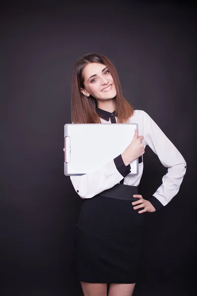 Smiling business woman holding blank clipboard — Stock Photo, Image