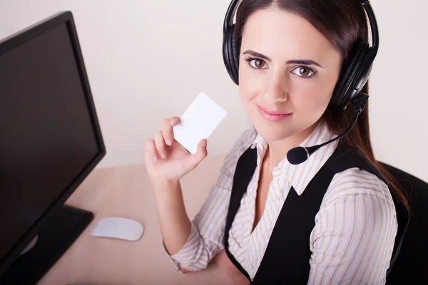 Call center woman with headset showing business card. — Stock Photo, Image