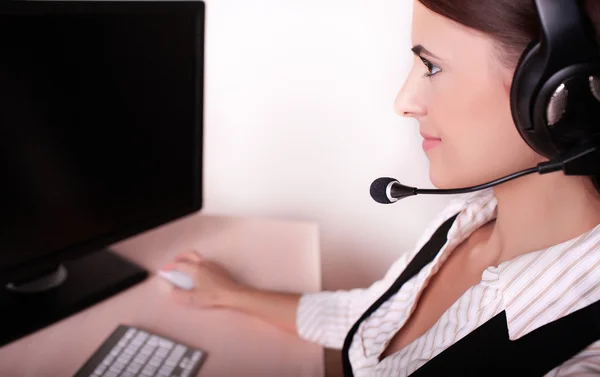 Businesswoman with headset working on computer — Stock Photo, Image