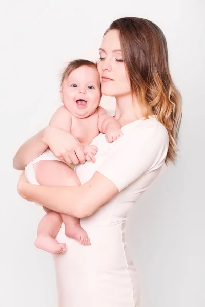 Happy mother and baby laughing in the studio — Stock Photo, Image
