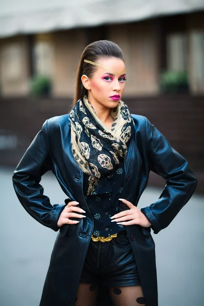 Portrait of a young beautiful woman in a urban background