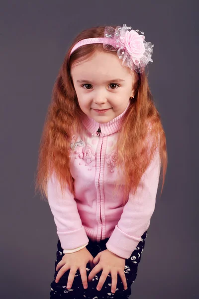 Beautiful young elementary age school girl with long curly red h — Stock Photo, Image