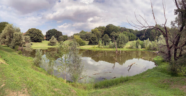 Small lake at the Lambro Park in Milan, Italy. The Lambro Park is one of the largest in the city of Milan.