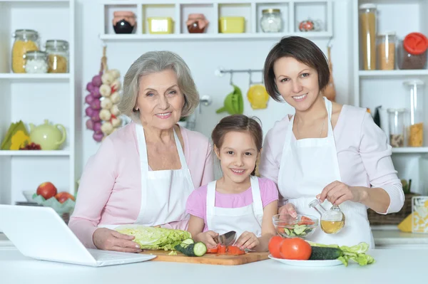 Women with little girl cooking — Stock Photo, Image