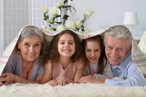 Happy senior couple with grandchildren