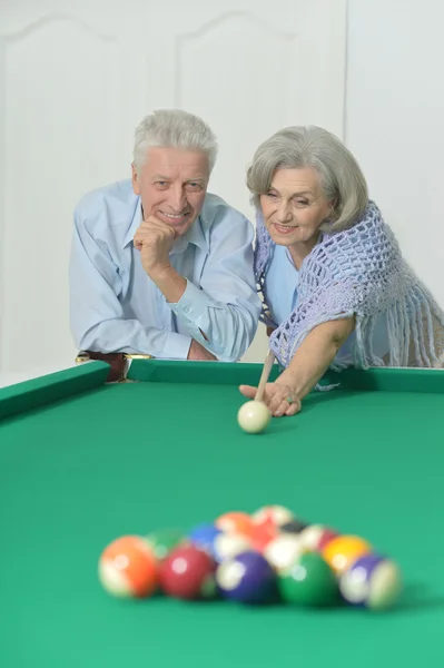 Old couple playing billiard — Stock Photo, Image