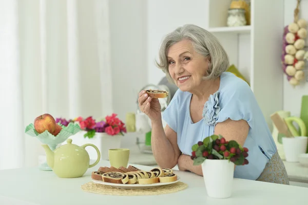 Äldre kvinna med välsmakande paj — Stockfoto