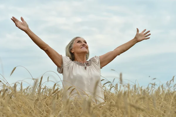 Senior woman in summer field — Stock Photo, Image