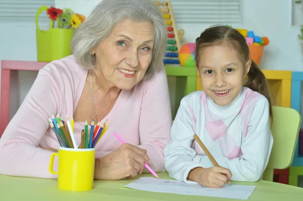 Grandmother with granddaughter drawing together — Stock Photo, Image