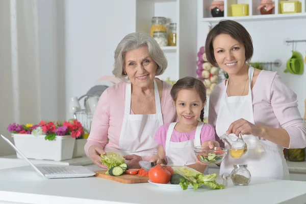 Women with little girl cooking — Stock Photo, Image