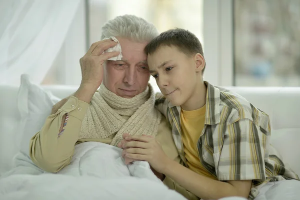 Portrait of sick  senior man with grandson — Stock Photo, Image