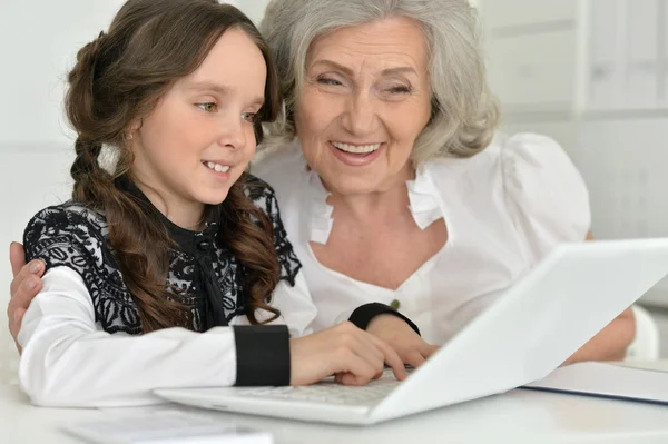 Kleines Mädchen macht Hausaufgaben mit Oma — Stockfoto