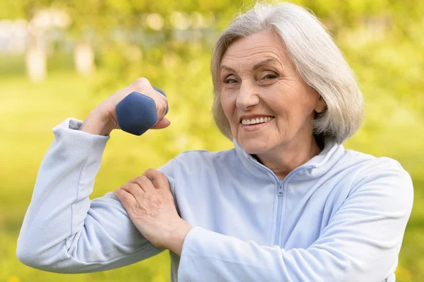 Mature woman with dumbbell — Stock Photo, Image