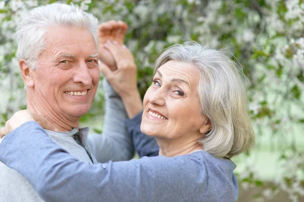 Mature couple in spring park — Stock Photo, Image