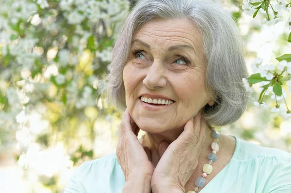 Older woman with  flowers — Stock Photo, Image