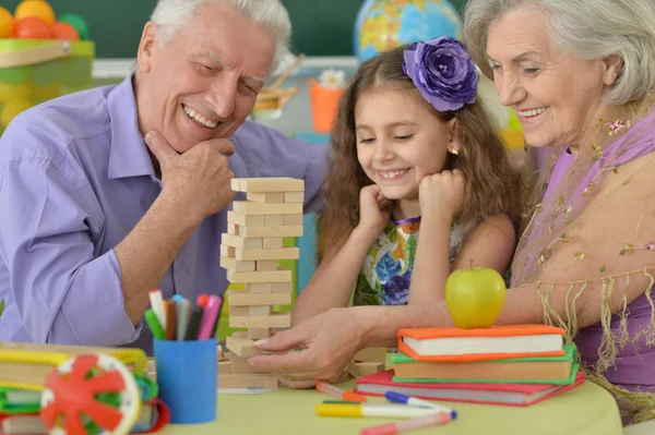 Grandparents with granddaughter playing together — Stock Photo, Image