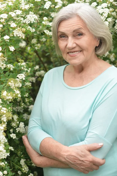 Mature couple in spring park — Stock Photo, Image