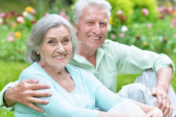 Mature couple in spring park — Stock Photo, Image