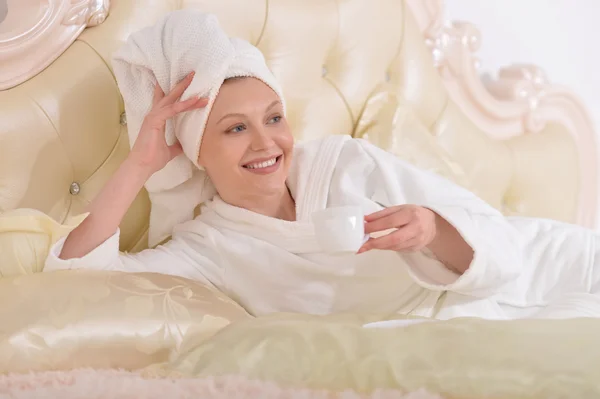 Young woman wearing a white bathrobe — Stock Photo, Image