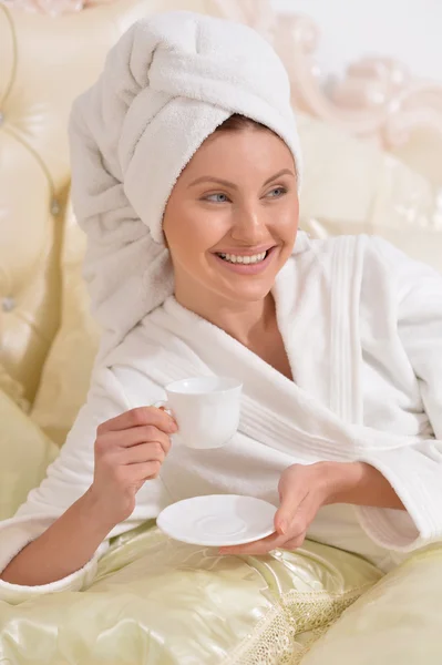 Young woman wearing a white bathrobe — Stock Photo, Image