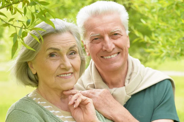 Mature couple in spring park — Stock Photo, Image