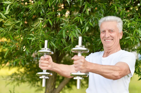 Starší muž cvičení s činkami — Stock fotografie