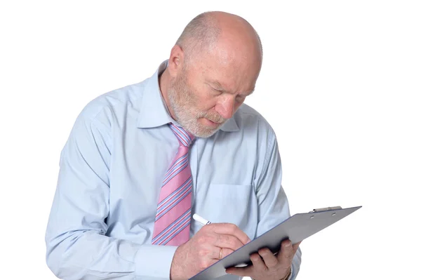 Elderly  businessman with clipboard — Stock Photo, Image