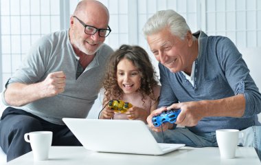 senior men and granddaughter with laptop  clipart