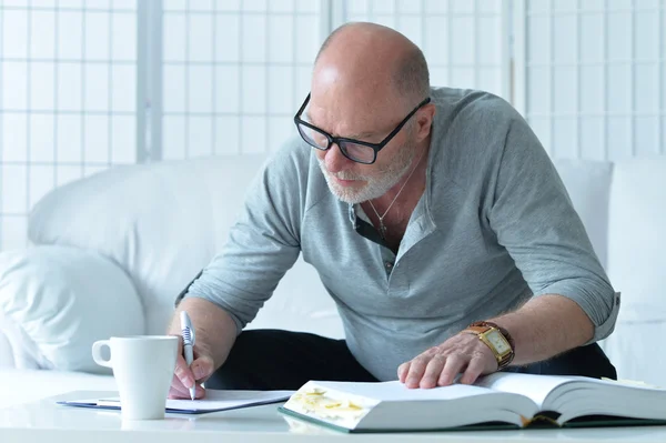 portrait of senior man with book