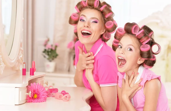 Mother and daughter in hair curlers — Stock Photo, Image