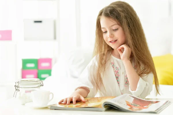 Krásná malá dívka čtení časopisu — Stock fotografie