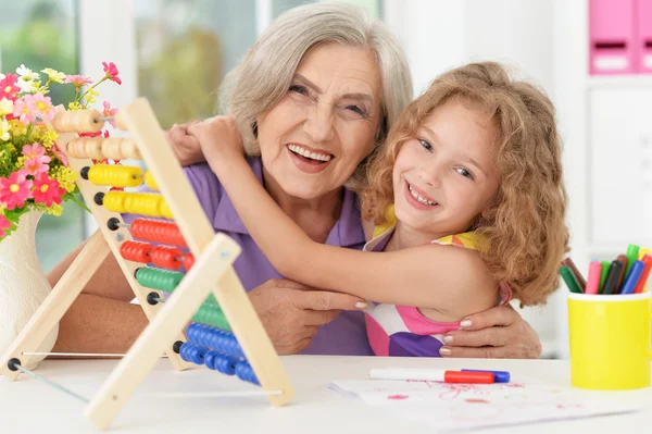 girl making homework with granny