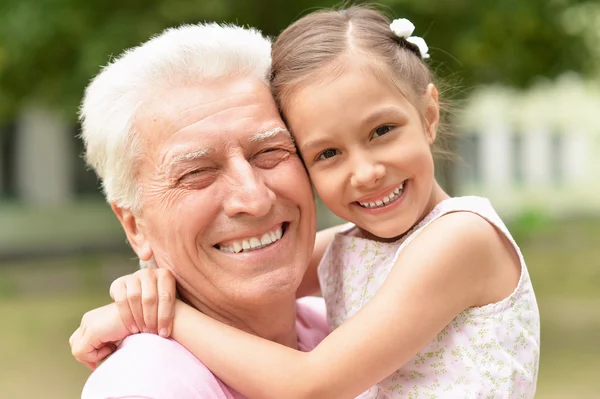 Man with granddaughter in spring park — Stock Photo, Image