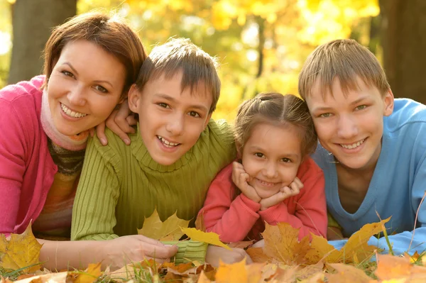 Family relaxing in autumn park — Stock Photo, Image