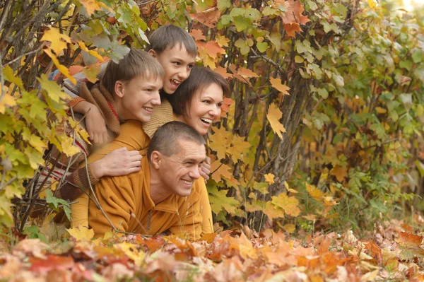 Happy family in autumn forest — Stock Photo, Image