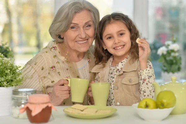 Stará žena s holkou pití čaje — Stock fotografie