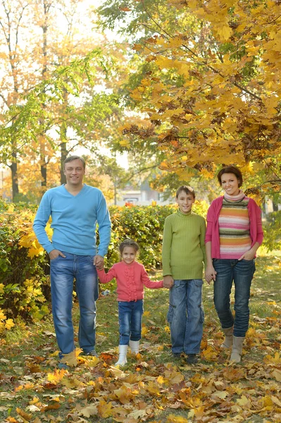 Happy family in autumn forest — Stock Photo, Image