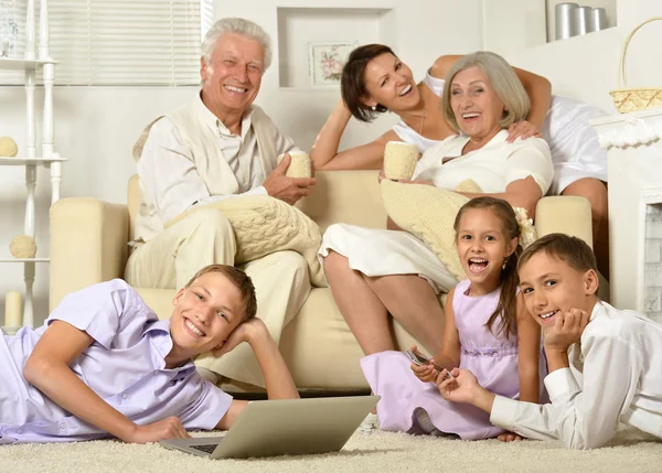 Happy family with kids with laptop — Stock Photo, Image
