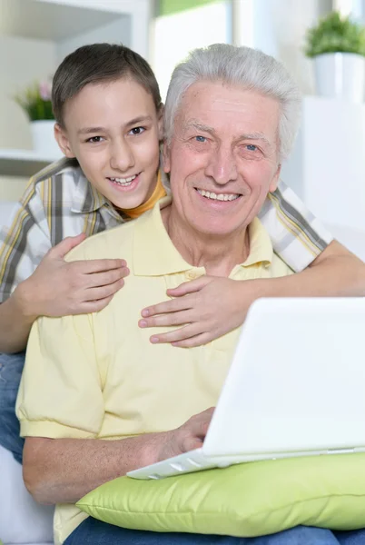 Boy and grandfather with  laptop — Stock Photo, Image