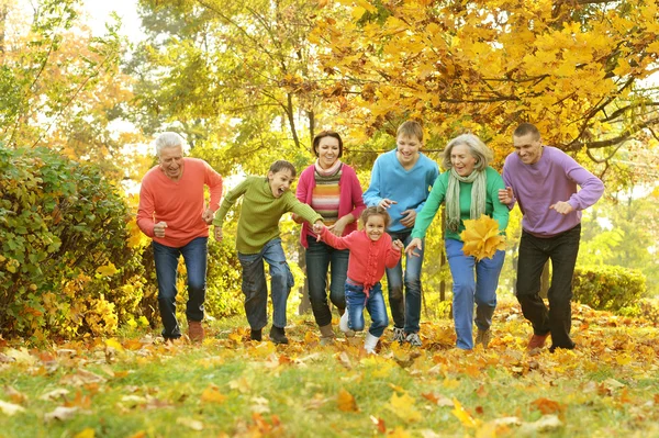 Happy family in autumn forest — Stock Photo, Image