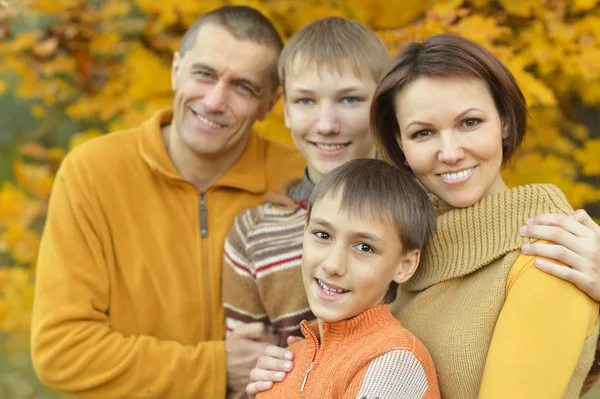 Happy family in autumn forest — Stock Photo, Image