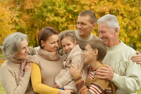 Family relaxing in autumn park — Stock Photo, Image