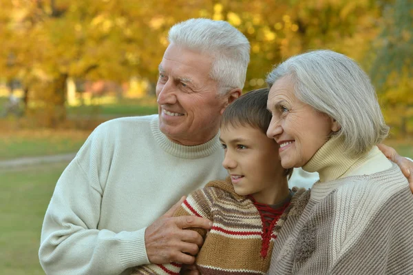 Grandparents and grandson in autumn park — Stock Photo, Image