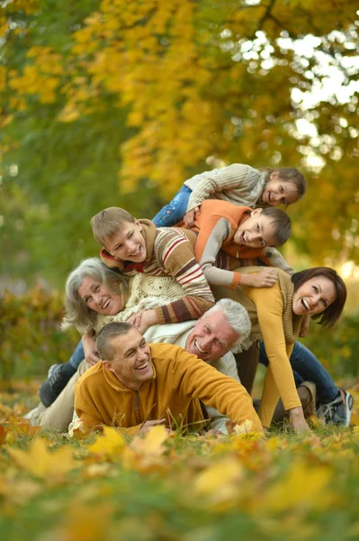 Happy family in autumn forest — Stock Photo, Image