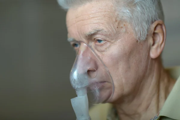 Elder man making inhalation — Stok fotoğraf