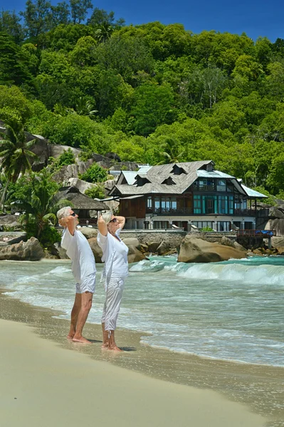 คู่รักผู้สูงอายุพักผ่อนที่ชายหาดเขตร้อน — ภาพถ่ายสต็อก