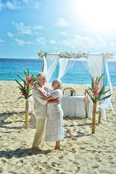 elderly couple dancing at tropical beach