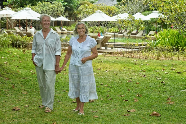 Pareja de ancianos descansan en resort tropical — Foto de Stock