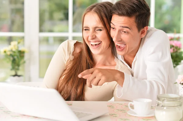 Casal feliz usando laptop em casa — Fotografia de Stock