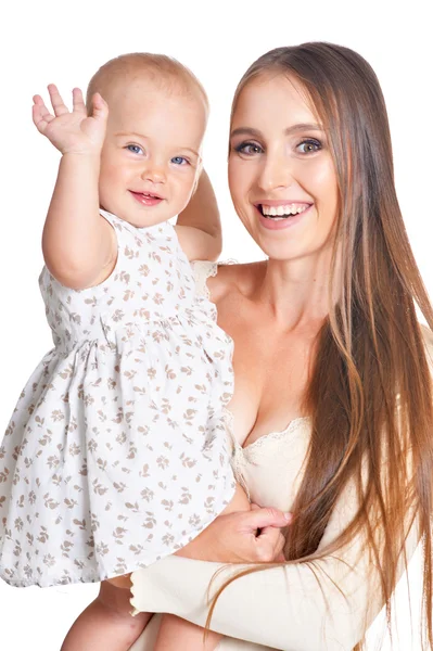 Frau mit kleiner Tochter auf einem weißen — Stockfoto